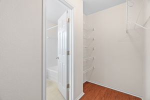 Walk in closet in primary bathroom area