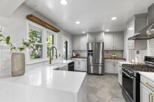 Open kitchen w quartz counters & stainless appls