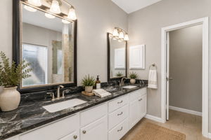 Modern spa-inspired bathroom with dual vanities