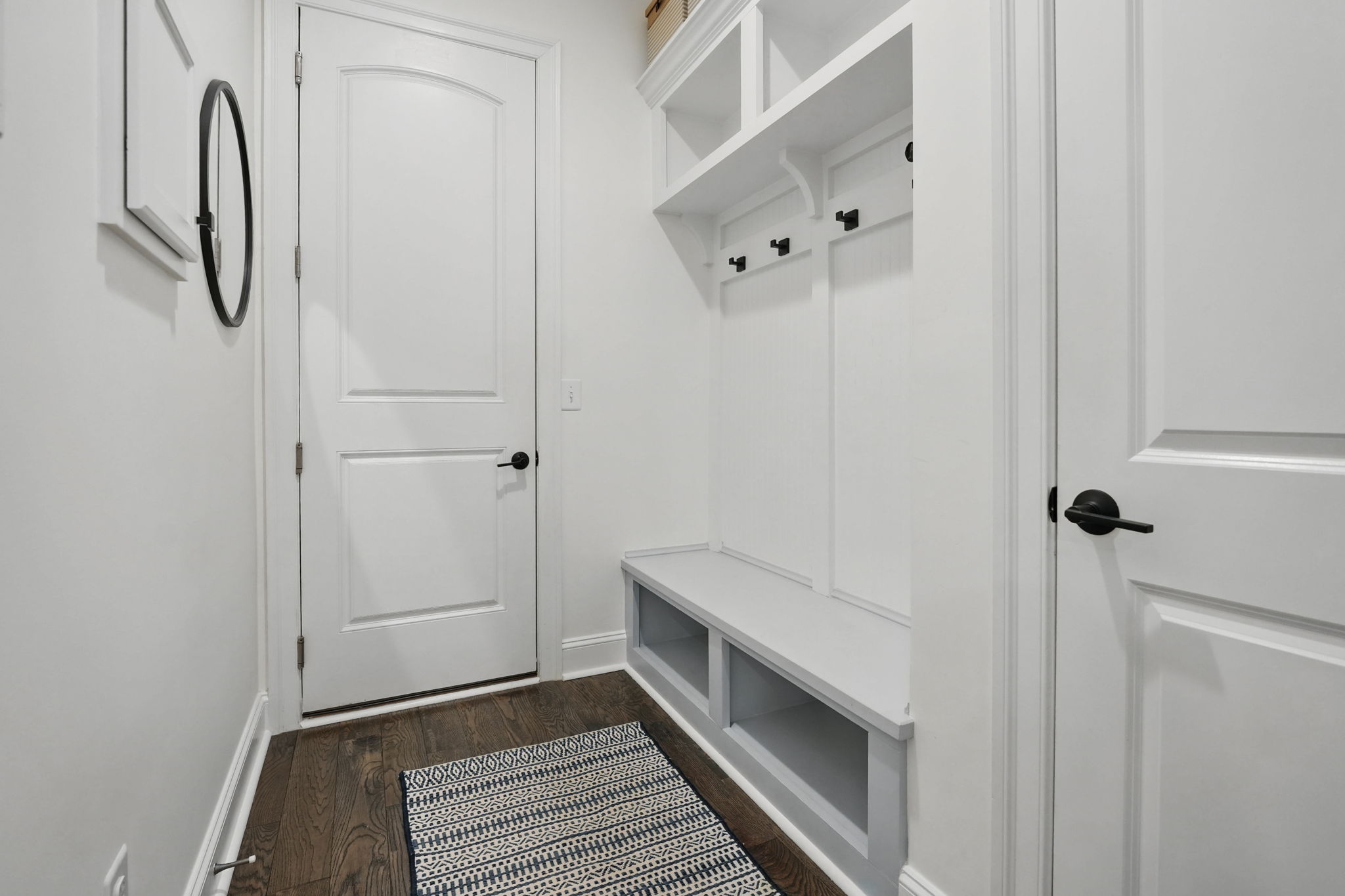 Beautiful family foyer with bench, shelves and additional coat closet