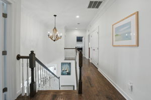 True hardwood flooring in hallway