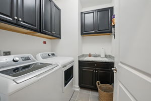 Laundry room on bedroom level w/ built-in sink and cabinets
