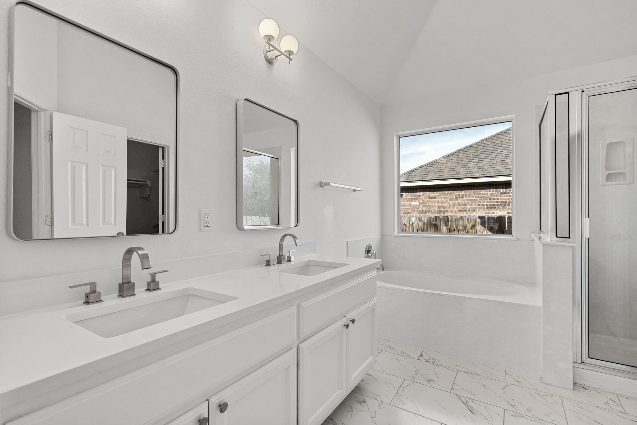 Gorgeous primary bathroom with stunning tile floors  and fixtures.