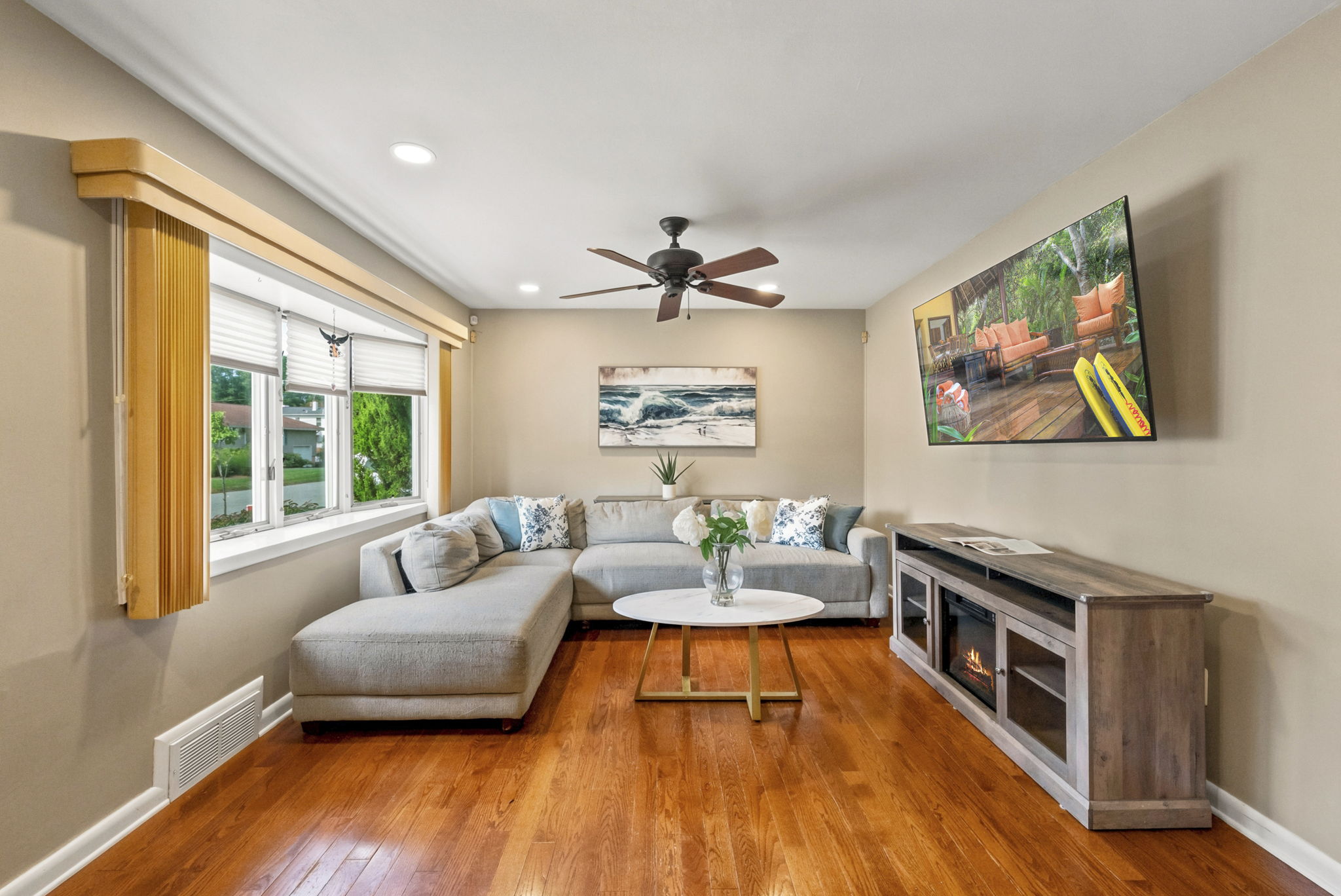 The light and bright living room features a wide front window, recessed lighting and hardwood floors that continue through most of the first floor.