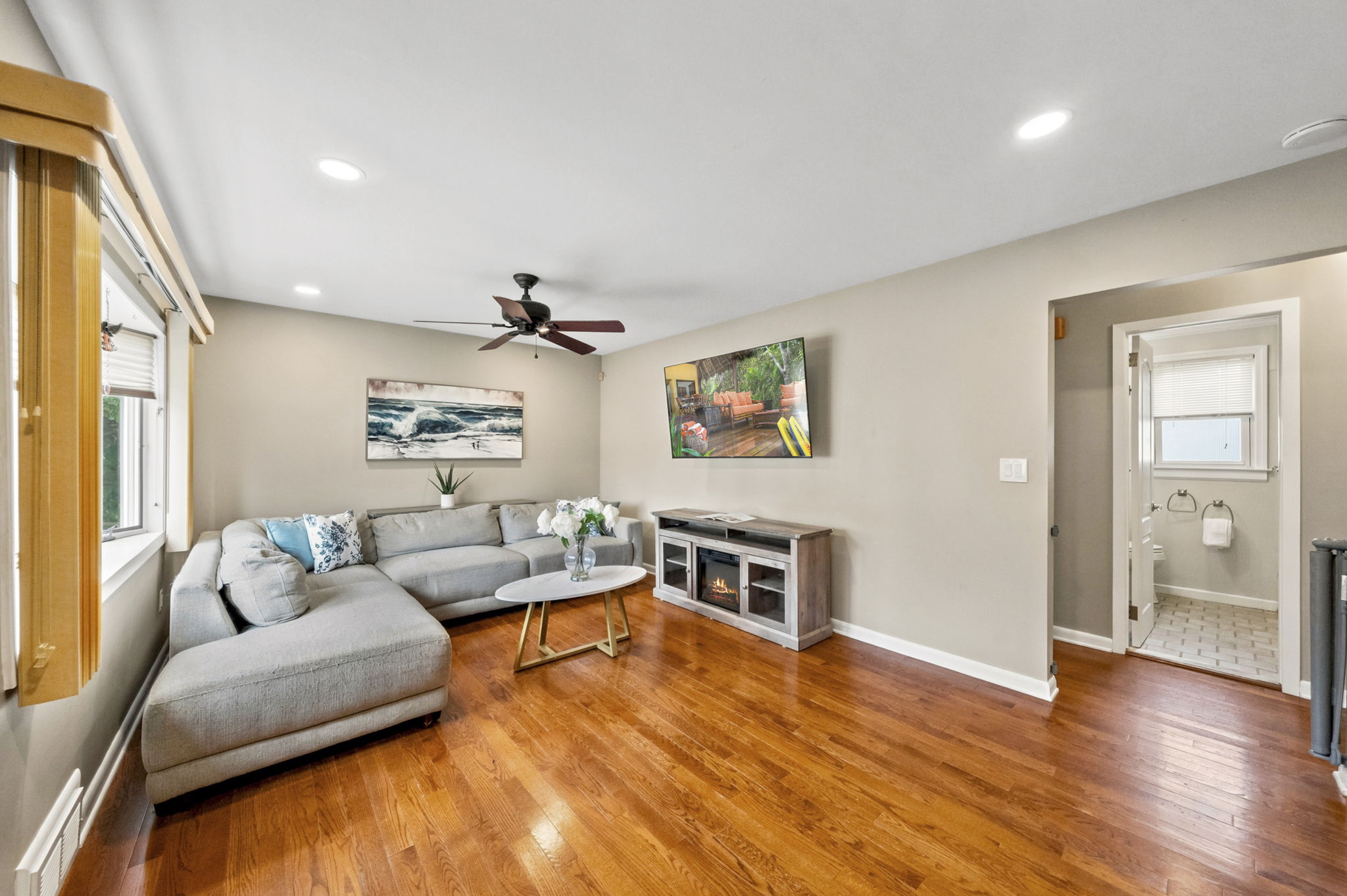 The light and bright living room features a wide front window, recessed lighting and hardwood floors that continue through most of the first floor.