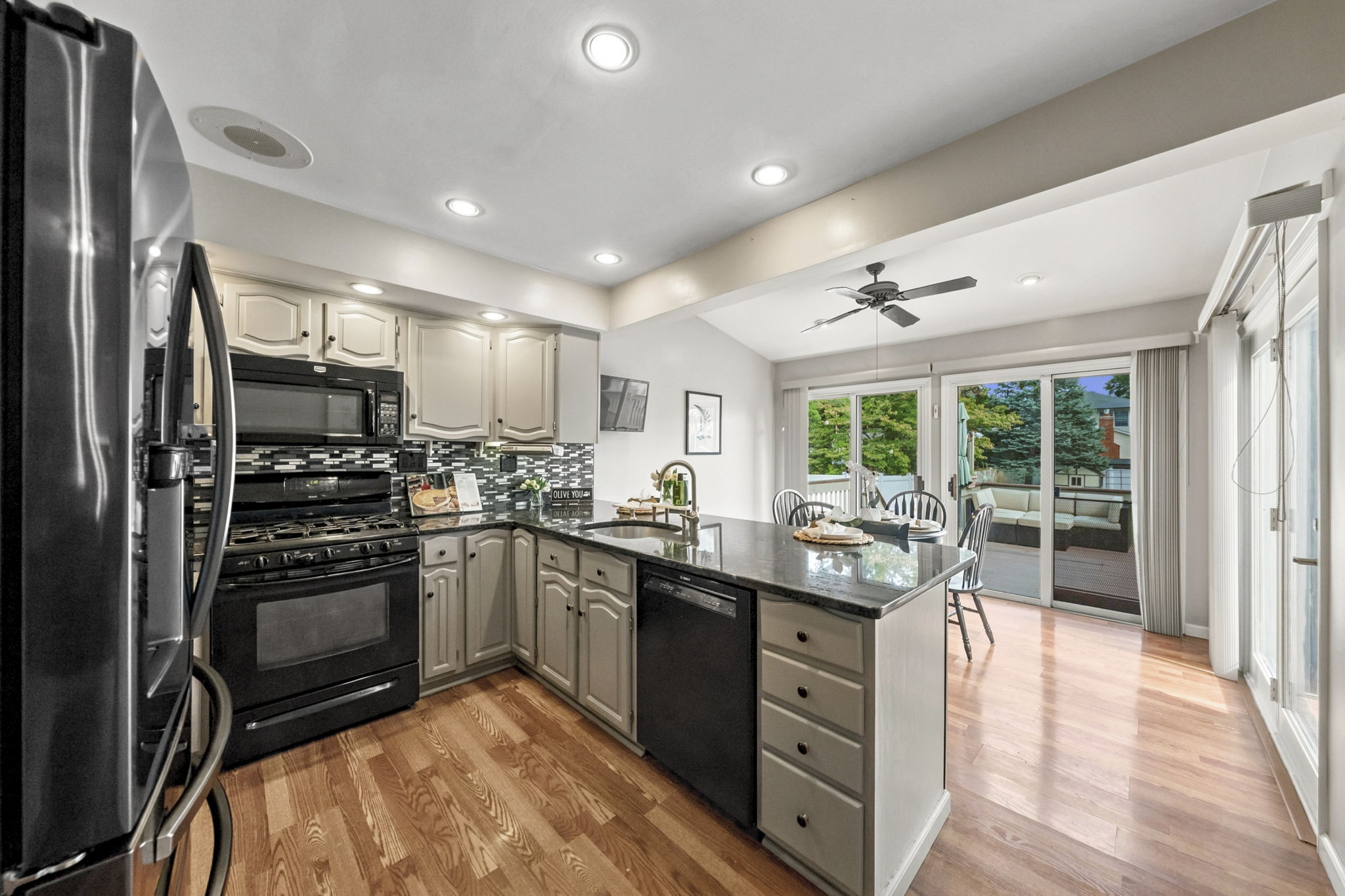 the kitchen addition opens directly to the spacious dining area created by the rear dormer. There’s generous counter space, an island for prep and room to gather around the table. When the weather is nice, open the two sliders and take the gathering outside.