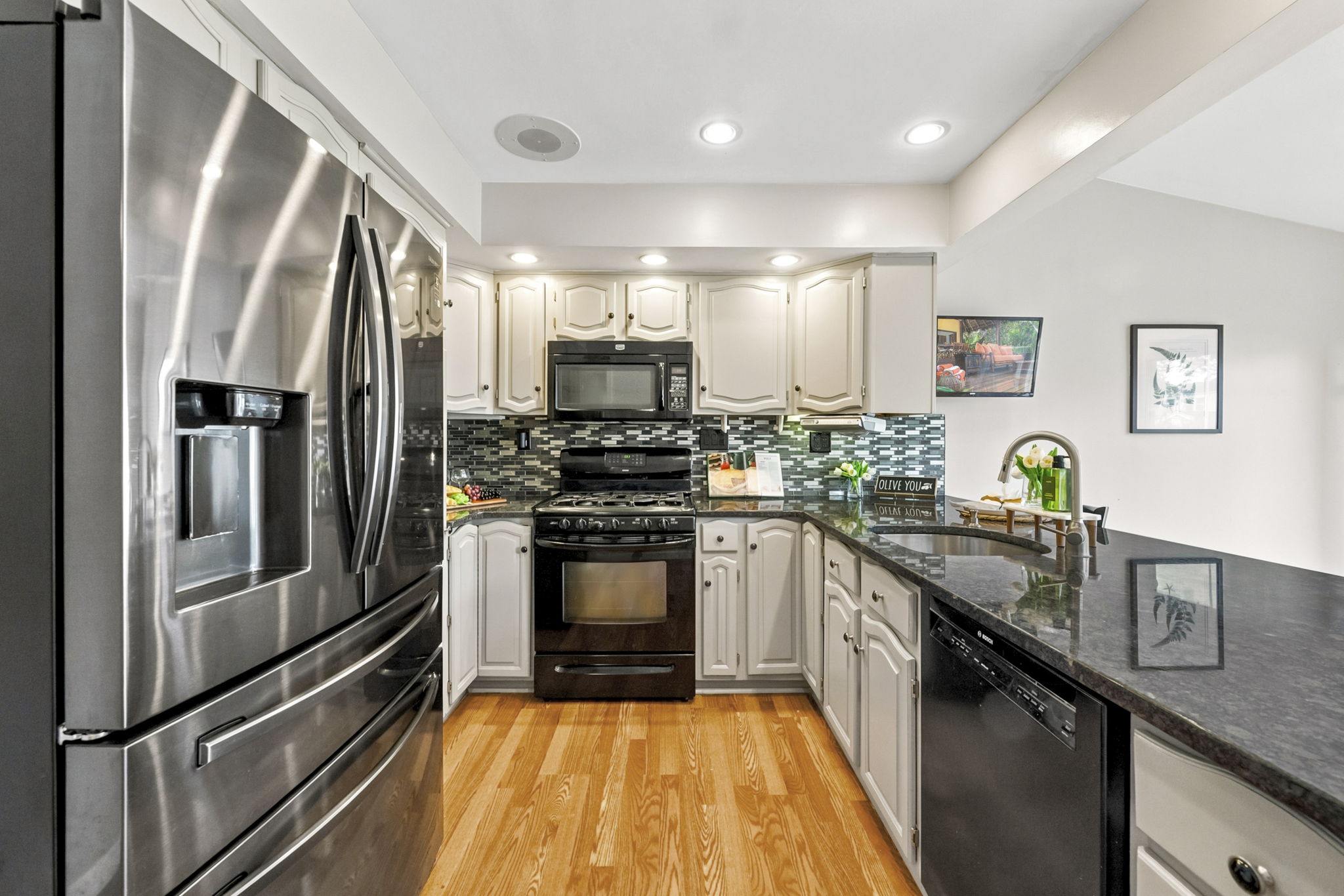 the kitchen addition opens directly to the spacious dining area created by the rear dormer. There’s generous counter space, an island for prep and room to gather around the table. When the weather is nice, open the two sliders and take the gathering outside.