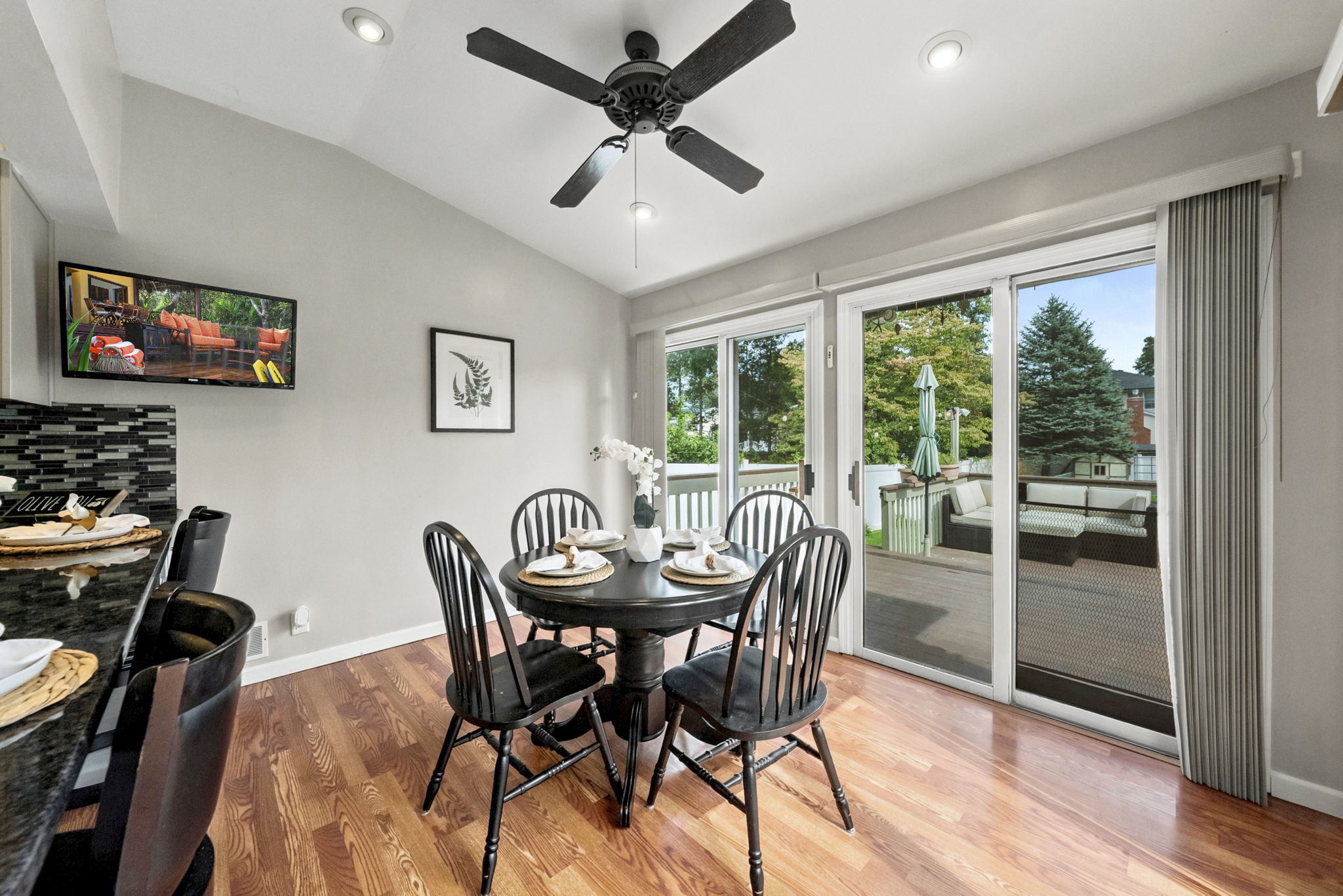 the kitchen addition opens directly to the spacious dining area created by the rear dormer. There’s generous counter space, an island for prep and room to gather around the table. When the weather is nice, open the two sliders and take the gathering outside.