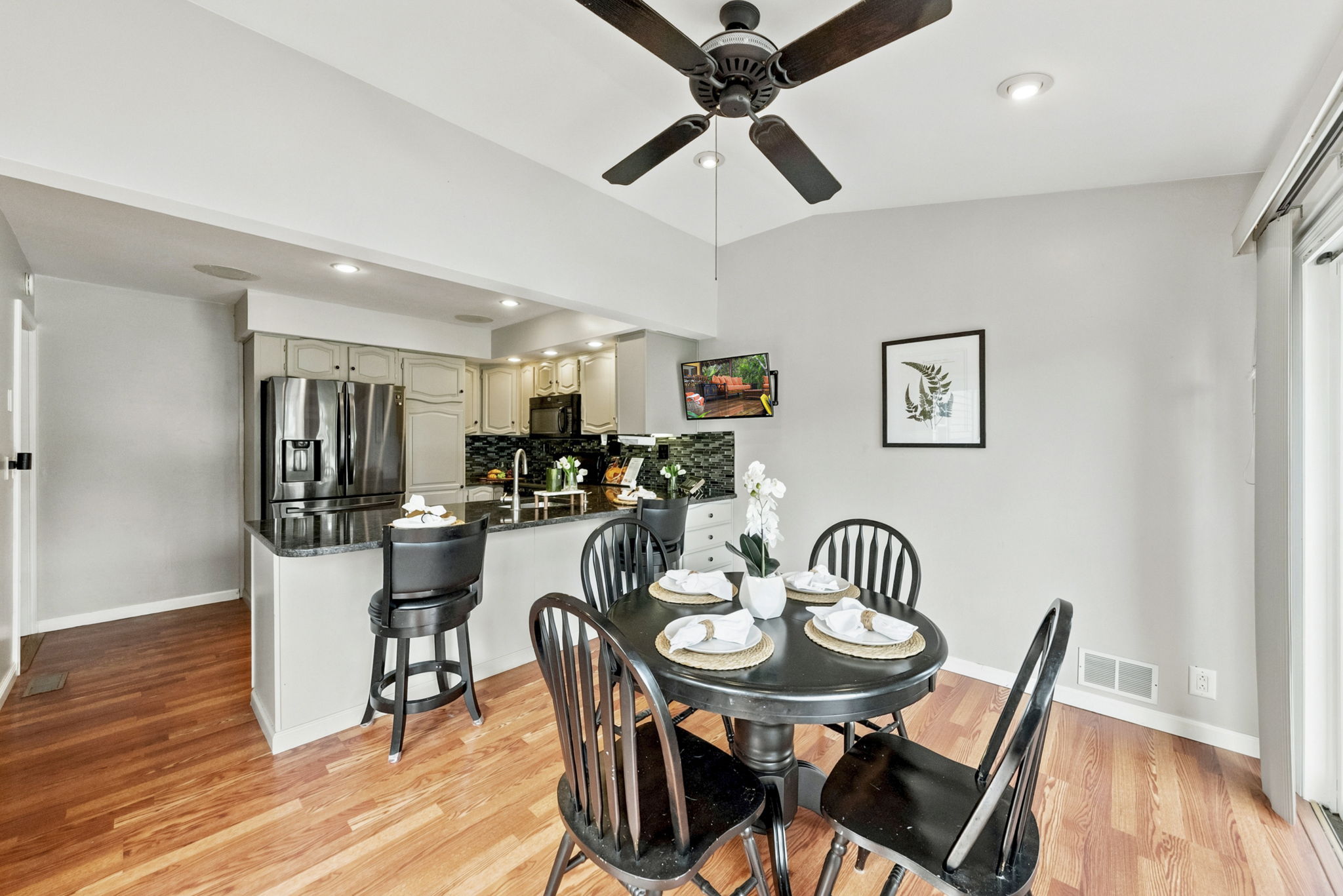 the kitchen addition opens directly to the spacious dining area created by the rear dormer. There’s generous counter space, an island for prep and room to gather around the table. When the weather is nice, open the two sliders and take the gathering outside.