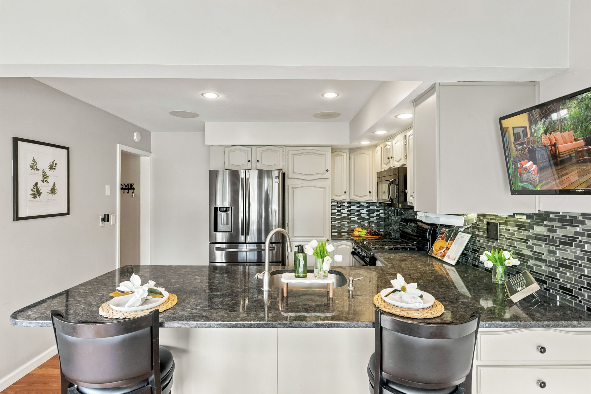the kitchen addition opens directly to the spacious dining area created by the rear dormer. There’s generous counter space, an island for prep and room to gather around the table. When the weather is nice, open the two sliders and take the gathering outside.