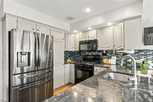 the kitchen addition opens directly to the spacious dining area created by the rear dormer. There’s generous counter space, an island for prep and room to gather around the table. When the weather is nice, open the two sliders and take the gathering outside.