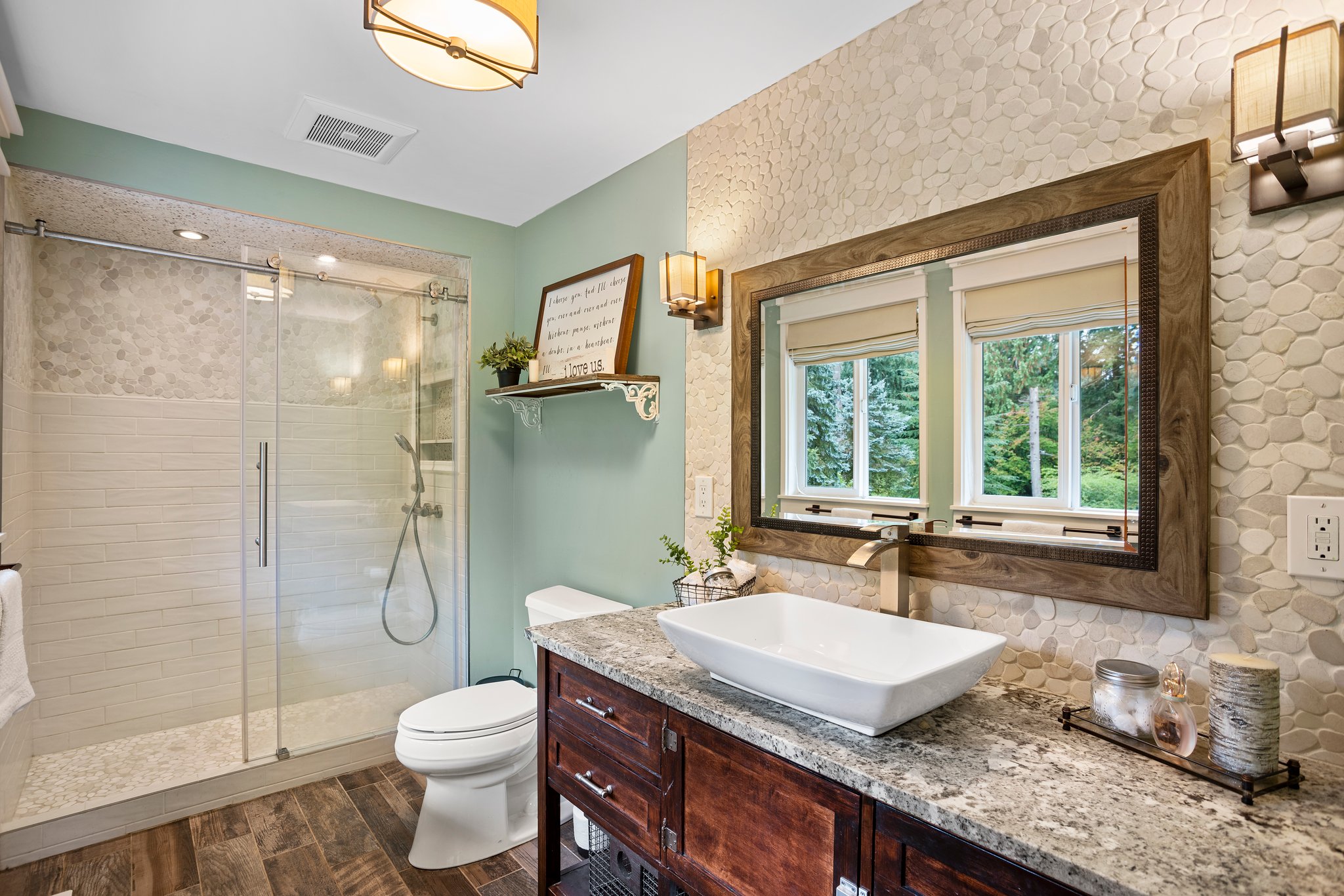 Gorgeous newly remodeled master bath!  Enjoy your personal spa like atmosphere with its custom made vanity and leathered granite countertops. The shower is fully tiled and the floors are new LVP