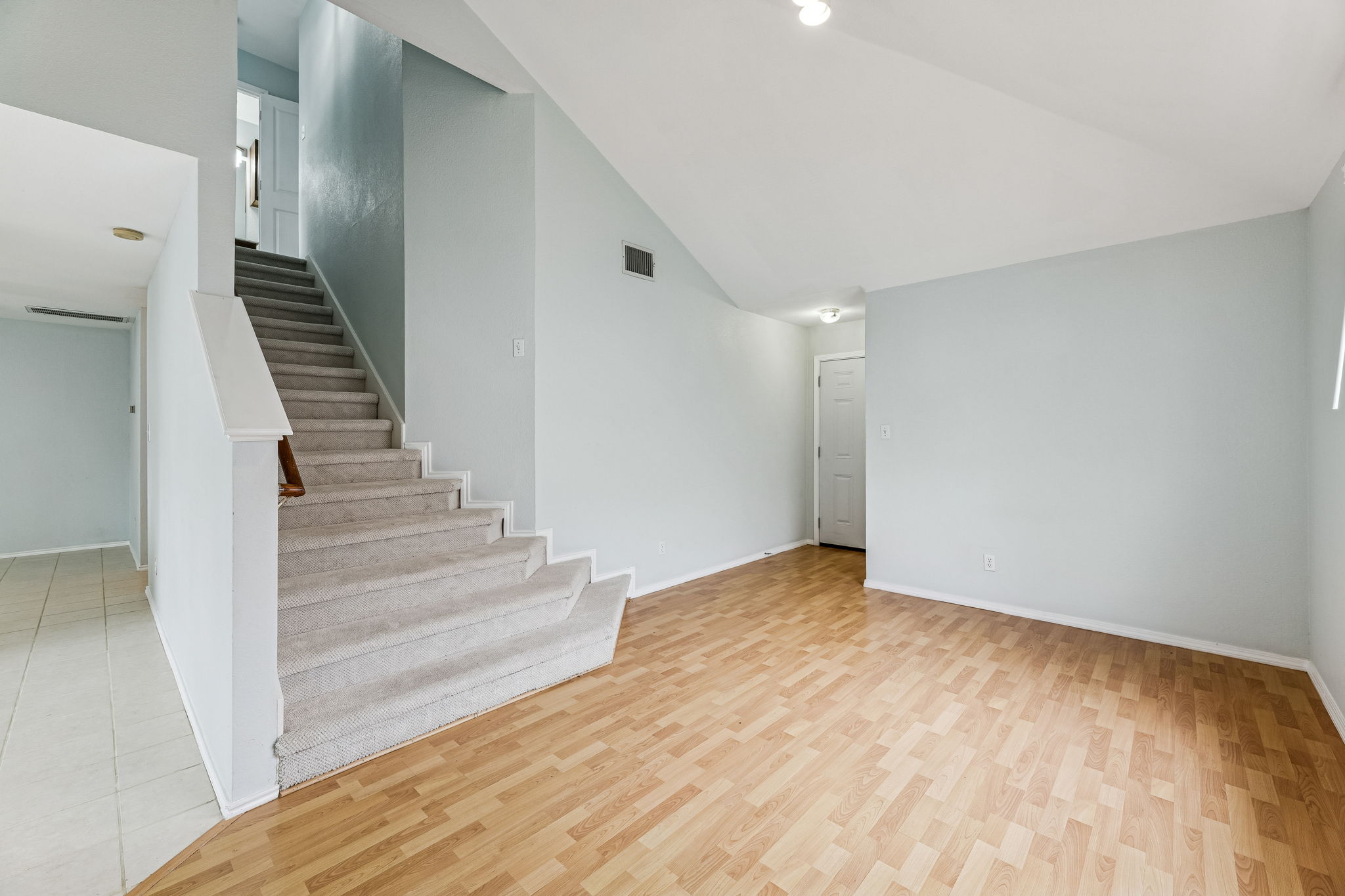 This secondary living room at the front of the house is perfect for a comfortable sitting area, musical instruments, a reading area, or a flex space for whatever you want.  The steps lead to the 3 upstairs bedrooms, including the primary bedroom.