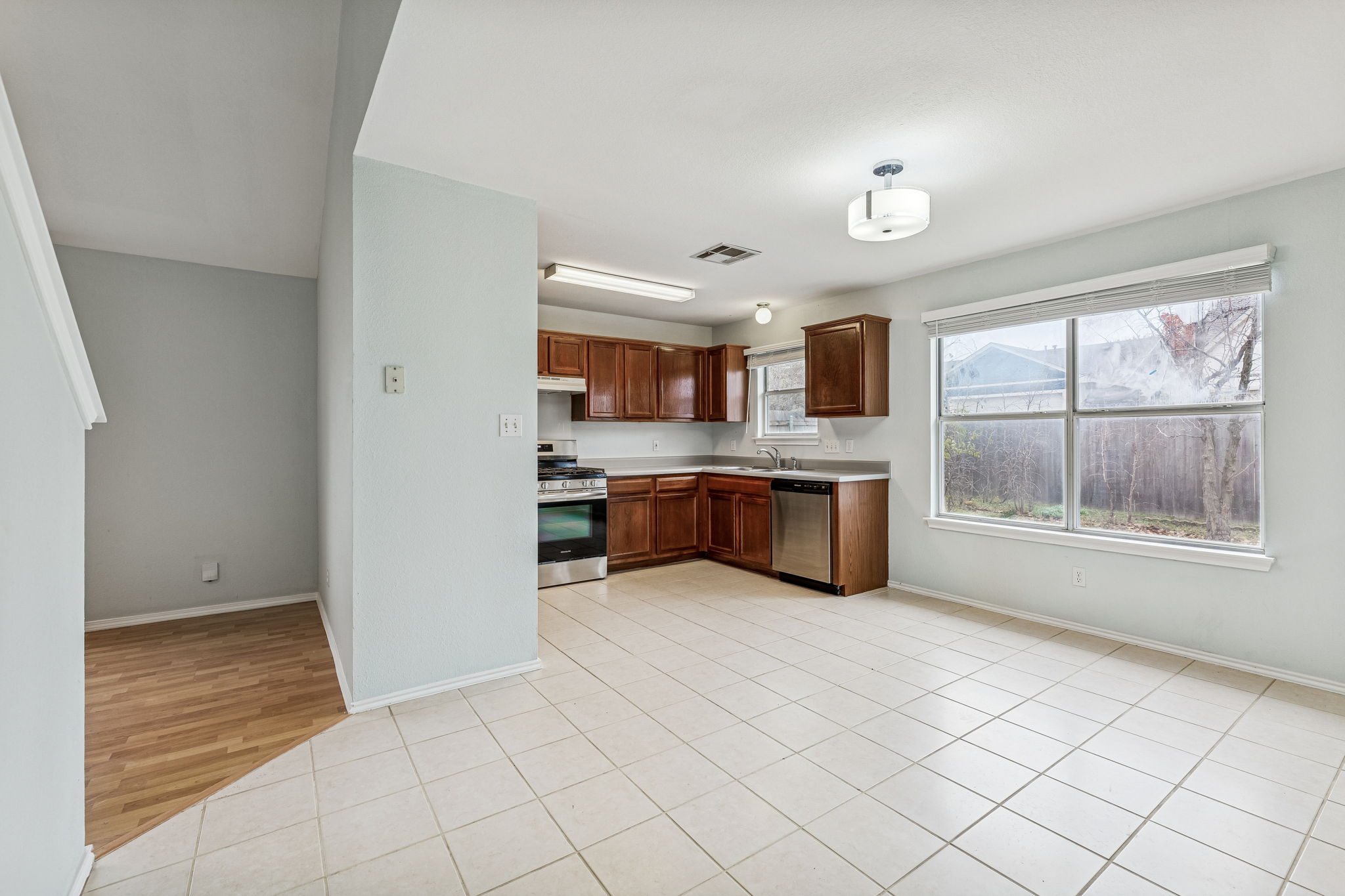 New stove & dishwasher, cabinets were recently refinished. Nice-sized dining area in front of the windows. The secondary living area is to the left of the kitchen.