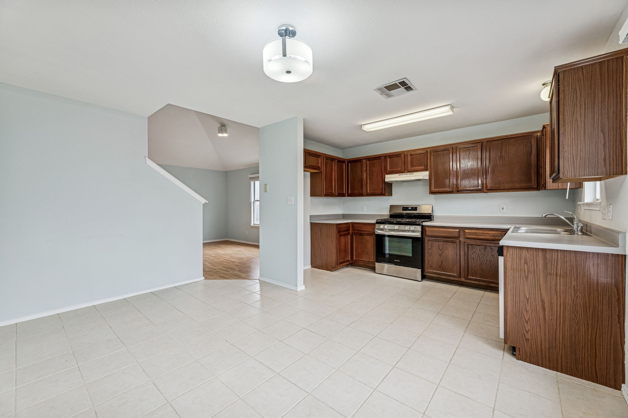 New stove & dishwasher, cabinets were recently refinished. Nice-sized dining area in front of the windows. The secondary living area is to the left of the kitchen.
