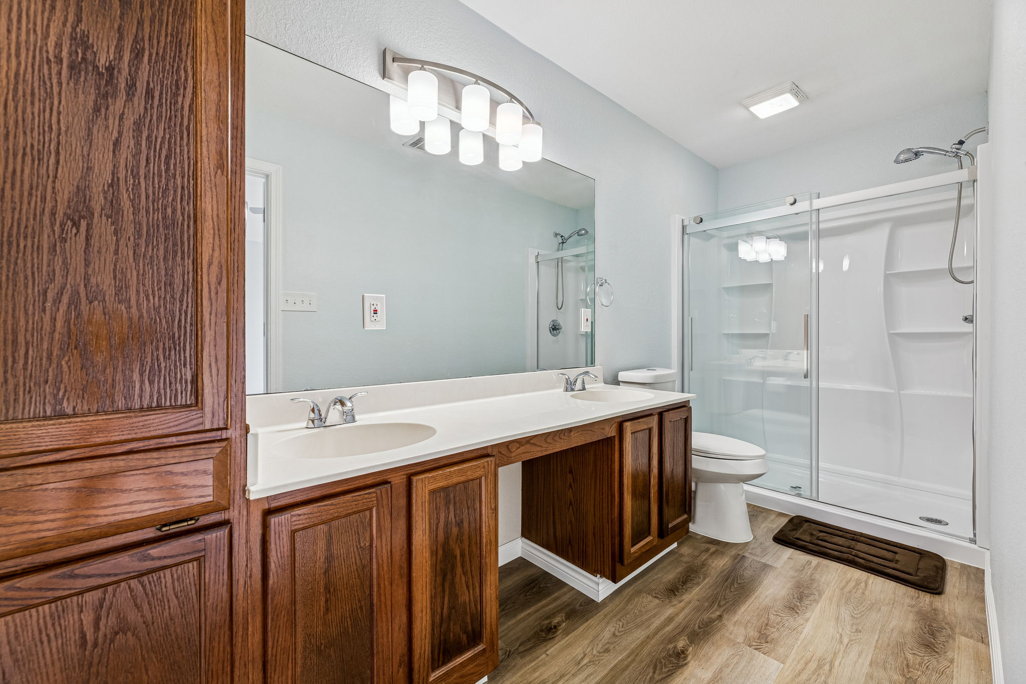 The primary bathroom offers a double vanity and walk-in shower.
