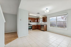 New stove & dishwasher, cabinets were recently refinished. Nice-sized dining area in front of the windows. The secondary living area is to the left of the kitchen.