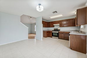 New stove & dishwasher, cabinets were recently refinished. Nice-sized dining area in front of the windows. The secondary living area is to the left of the kitchen.