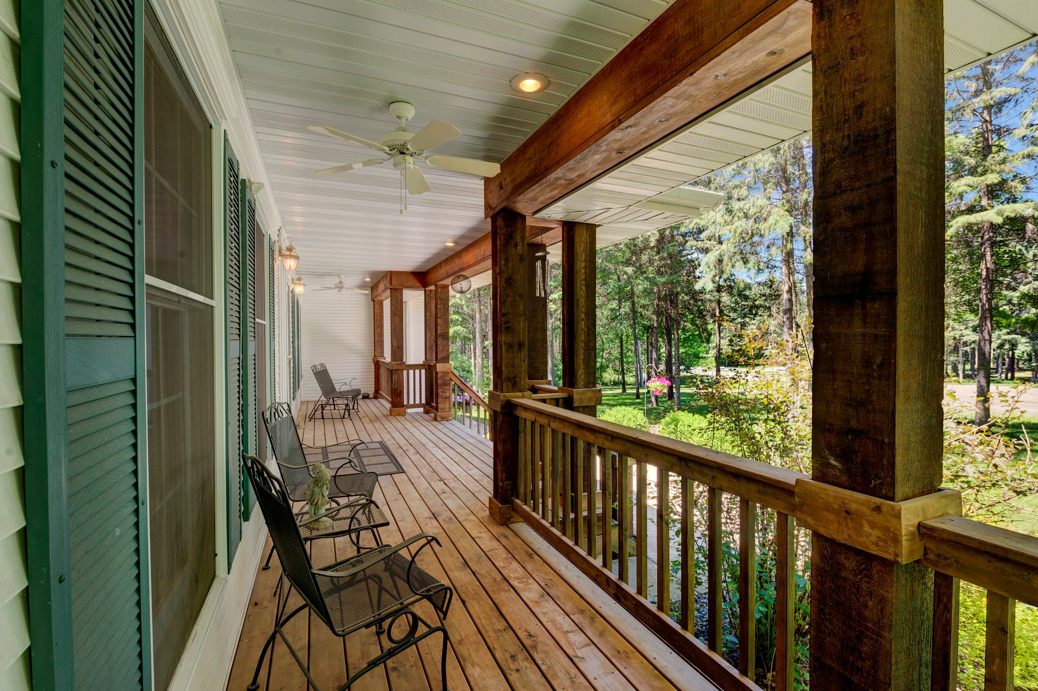 Tranquil front wrap around porch with ceiling fans