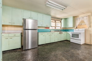 Charming retro kitchen with original built in cabinets that can be easily restored!