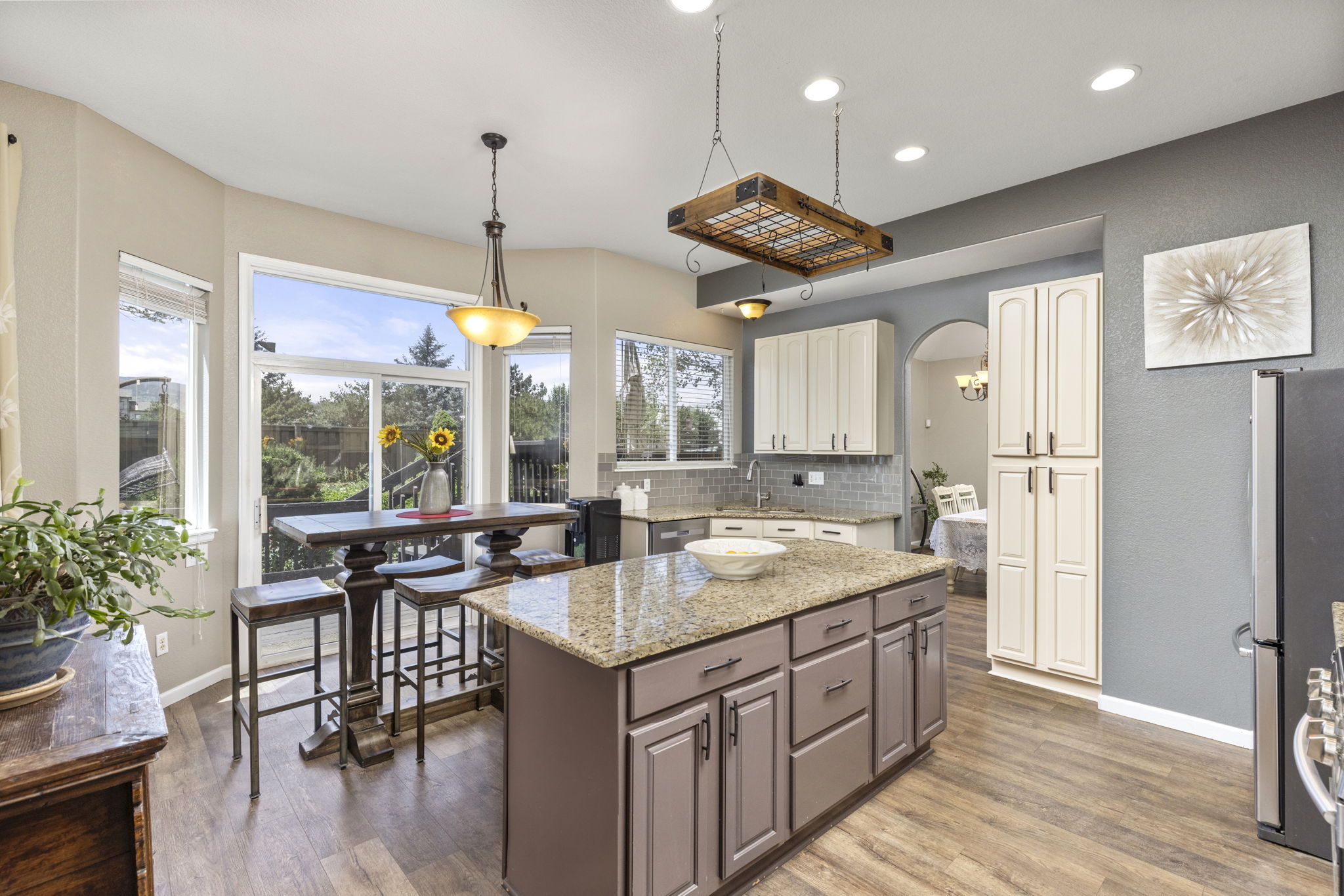 Upgraded kitchen. Custom-painted cabinets, granite counters, tile backsplash & stainless appliances. Breakfast island & nook