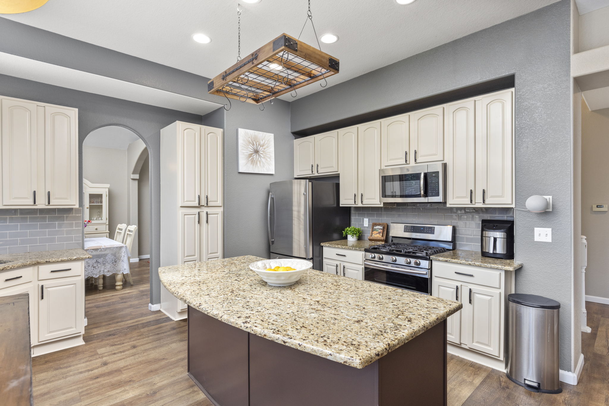 Upgraded kitchen. Custom-painted cabinets, granite counters, tile backsplash & stainless appliances. Breakfast island & nook. Gas range