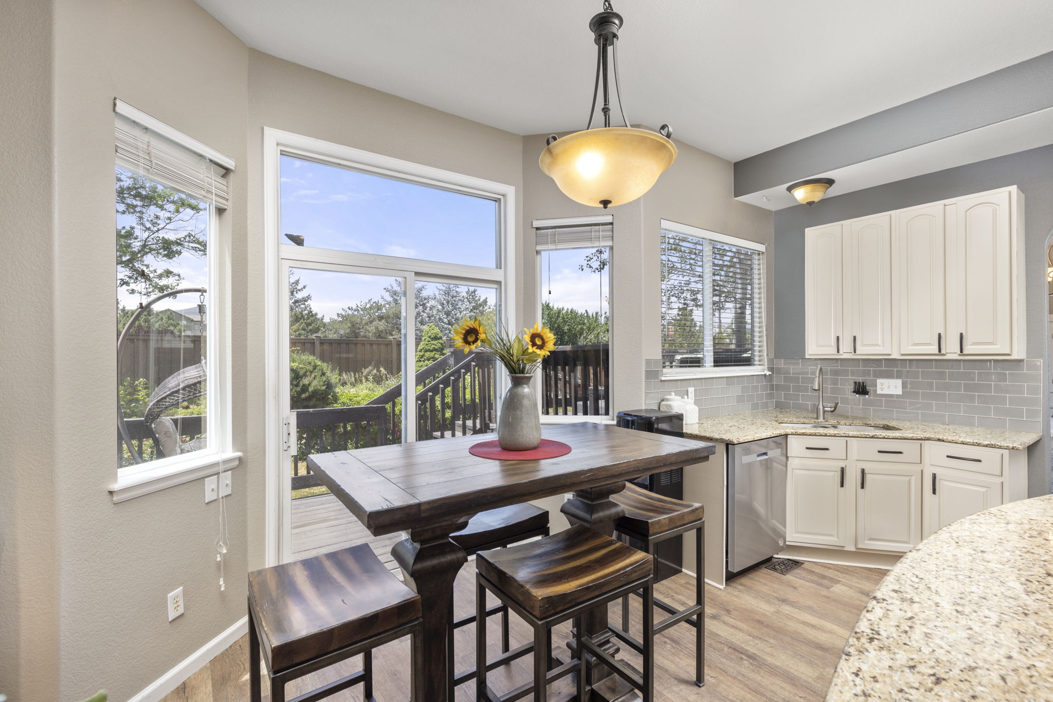 Upgraded kitchen. Custom-painted cabinets, granite counters, tile backsplash & stainless appliances. Breakfast island & nook