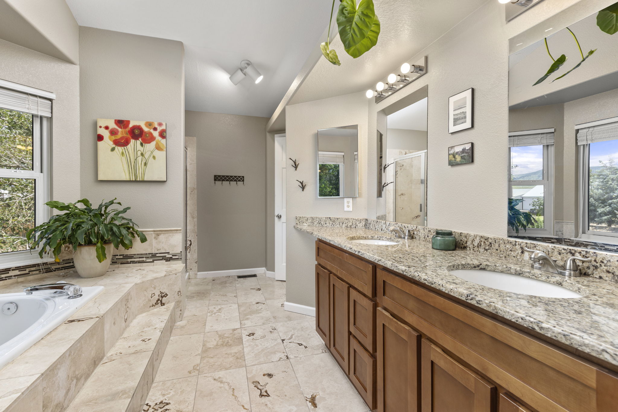 En-suite Primary bathroom. Natural stone tile floors, double vanity, granite counters, & luxurious soaking tub. Energy Star 3-pane windows