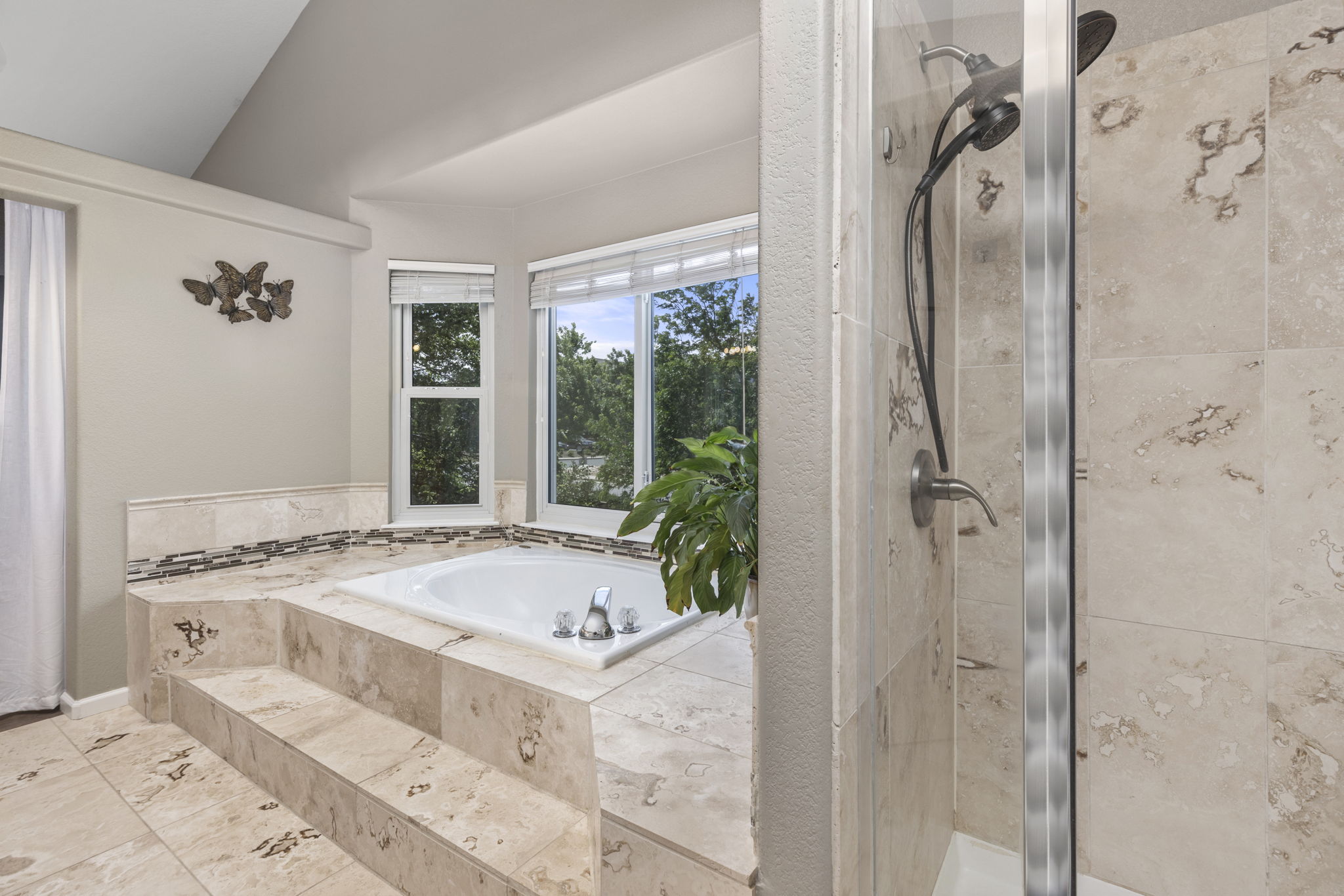 En-suite Primary bathroom. Natural stone tile floors, double vanity, granite counters, & soaking tub. Energy Star 3pane windows
