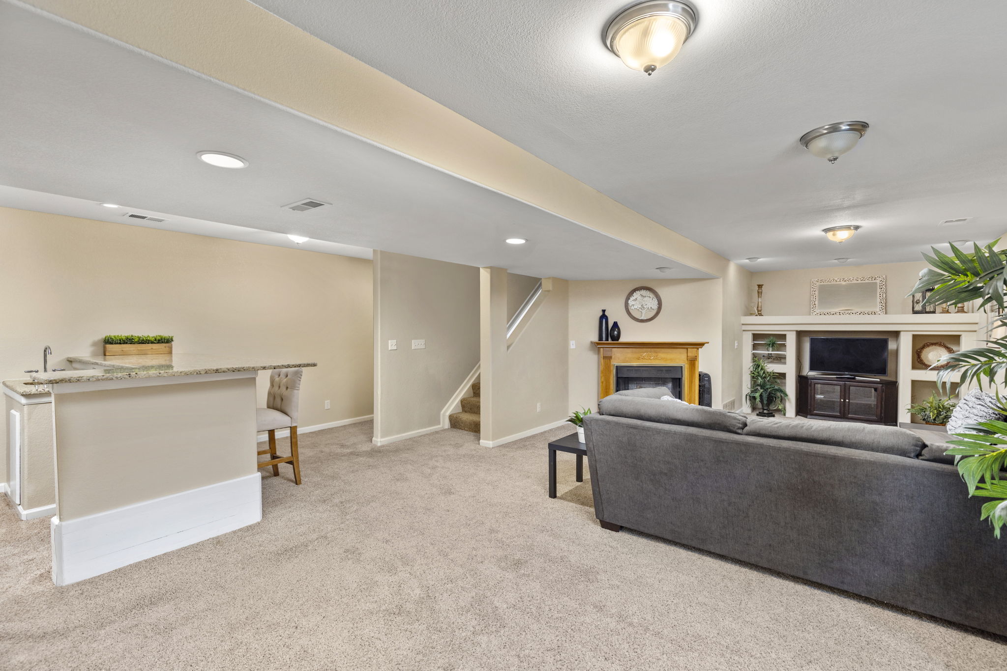 Fully finished Basement. Spacious playroom/fitness area with gas fireplace & built-ins. Nice bar w/granite counter, refrigerator & sink