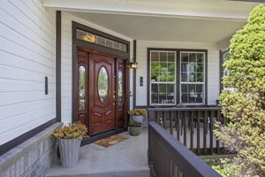 An idyllic front porch & charming entrance will welcome you