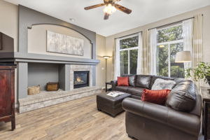 Spacious Family Room with gas fireplace & mantel. Built-ins, ceiling fan