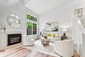 The living room features dramatic ceilings