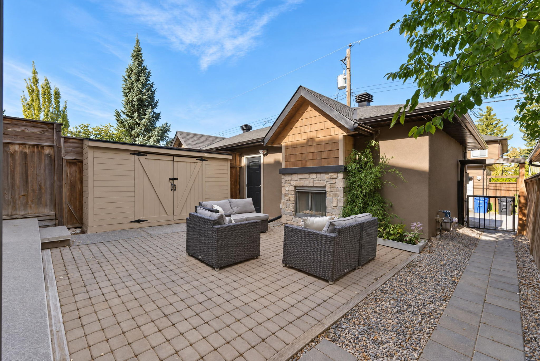Backyard patio with an outdoor gas fireplace