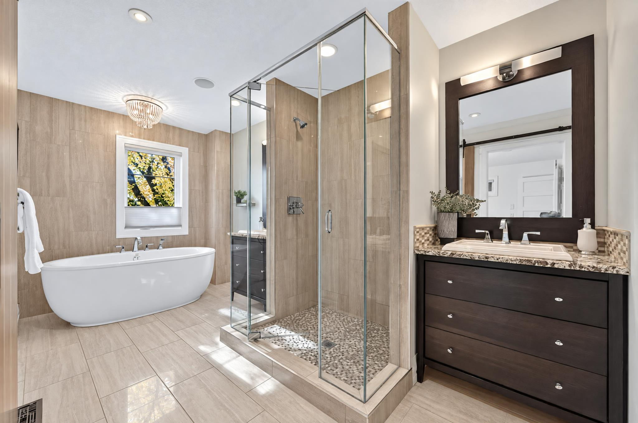 Ensuite with a soaker tub and glass shower