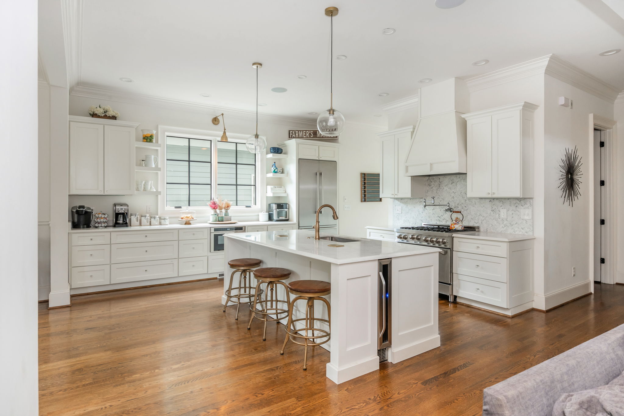 Open Kitchen with Large Island Including Custom Wine Fridge