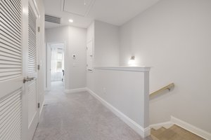 Upstairs hallway with pull-down ladder, storage closet on right and utility closet on left.