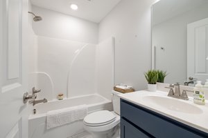 Full bathroom with shower/tub combo off the basement flex space.