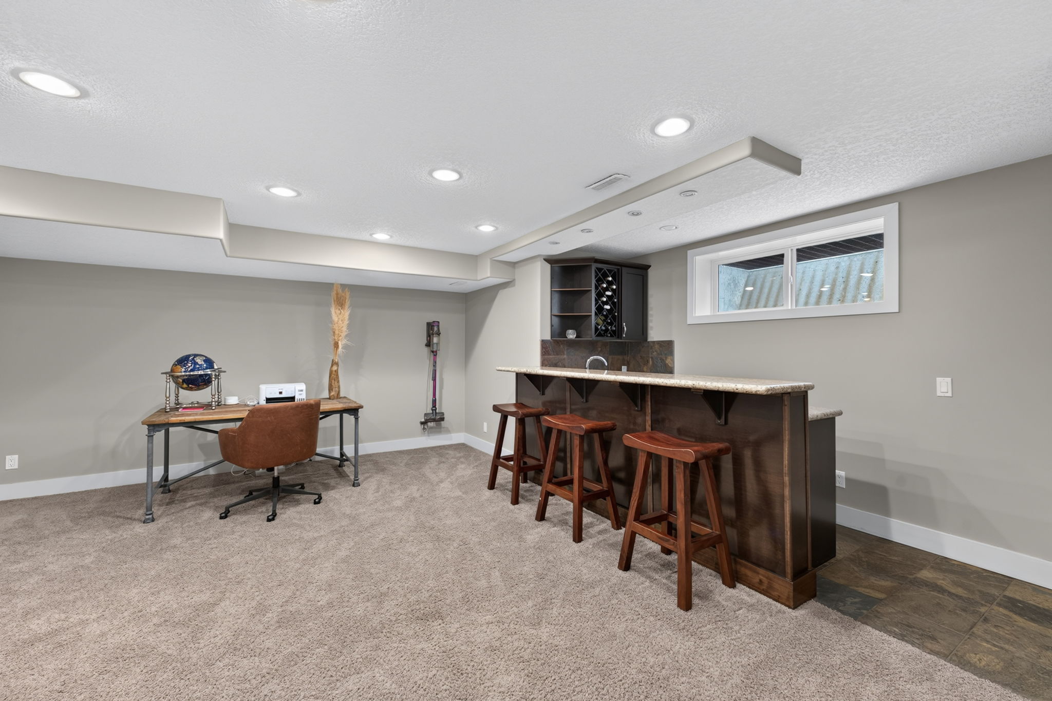 Lower-level recreation room with a wet bar