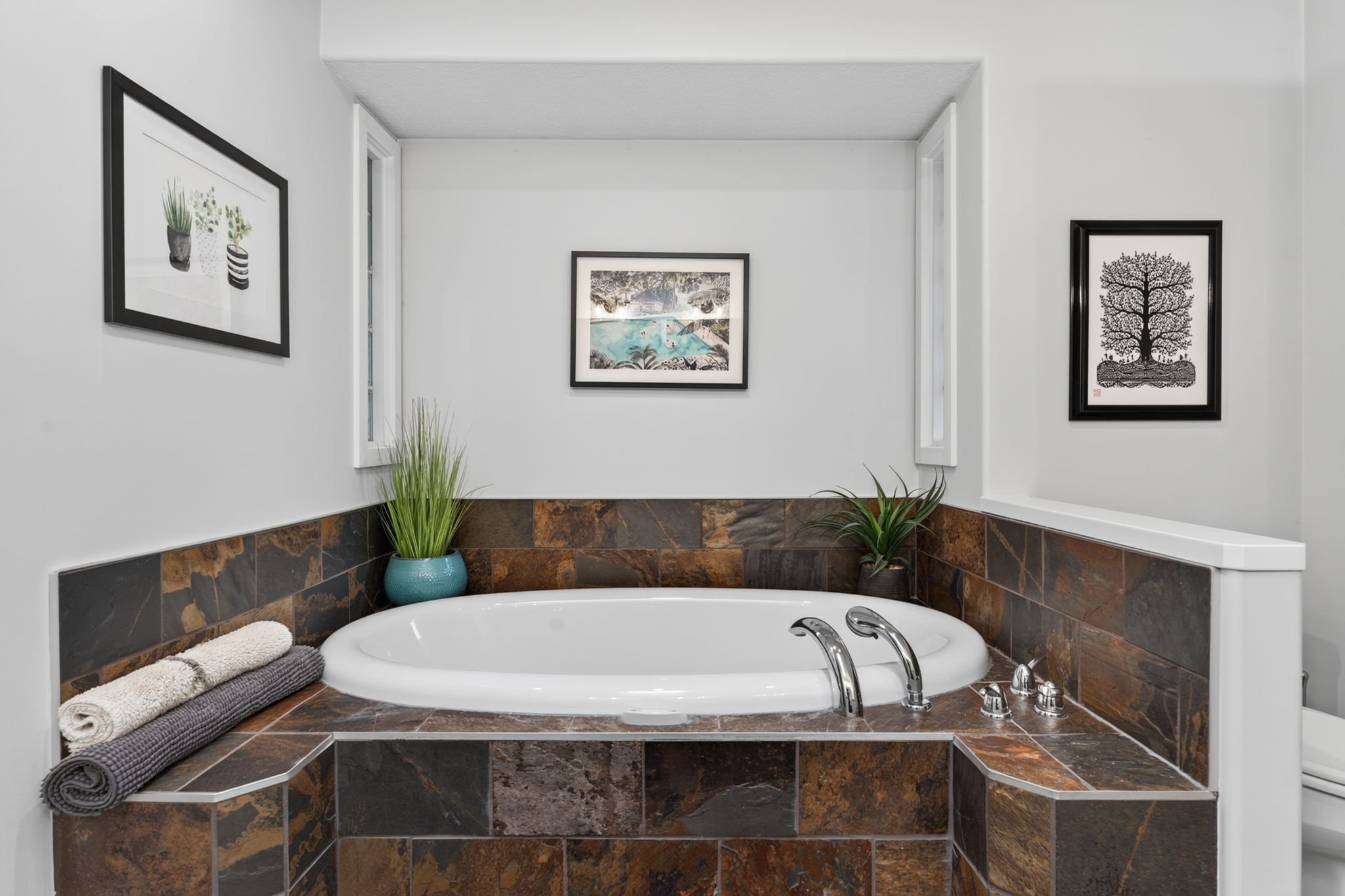 Primary ensuite with a deep soaker tub in slate