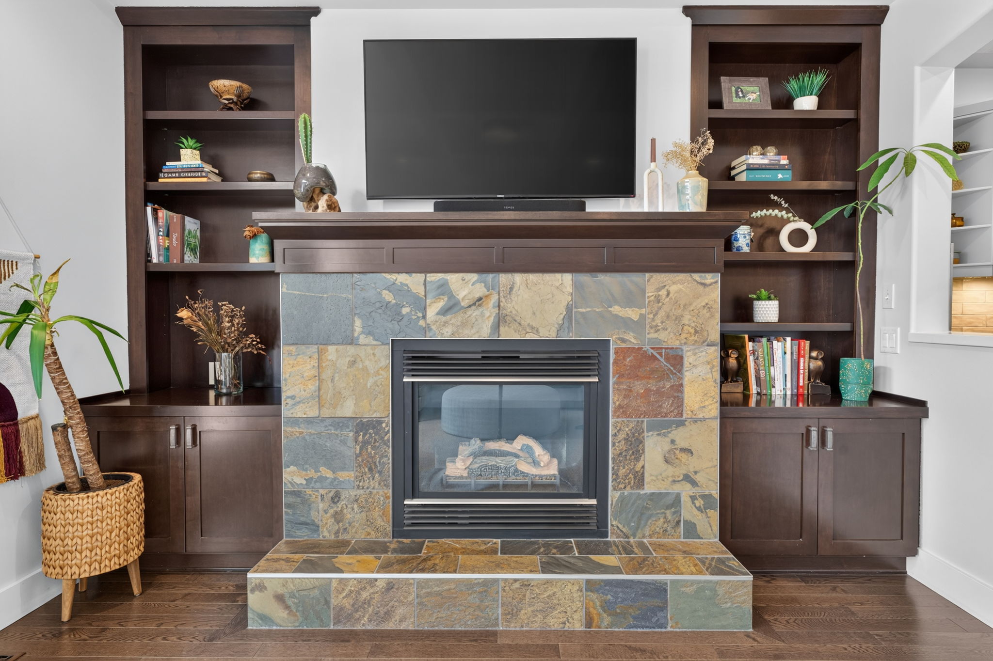 Living room built around a slate-wrapped gas fireplace with built-ins