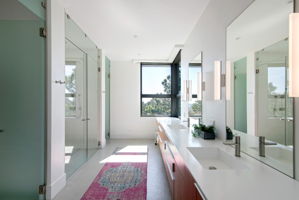 Luxurious primary bathroom with his and hers toilette rooms.