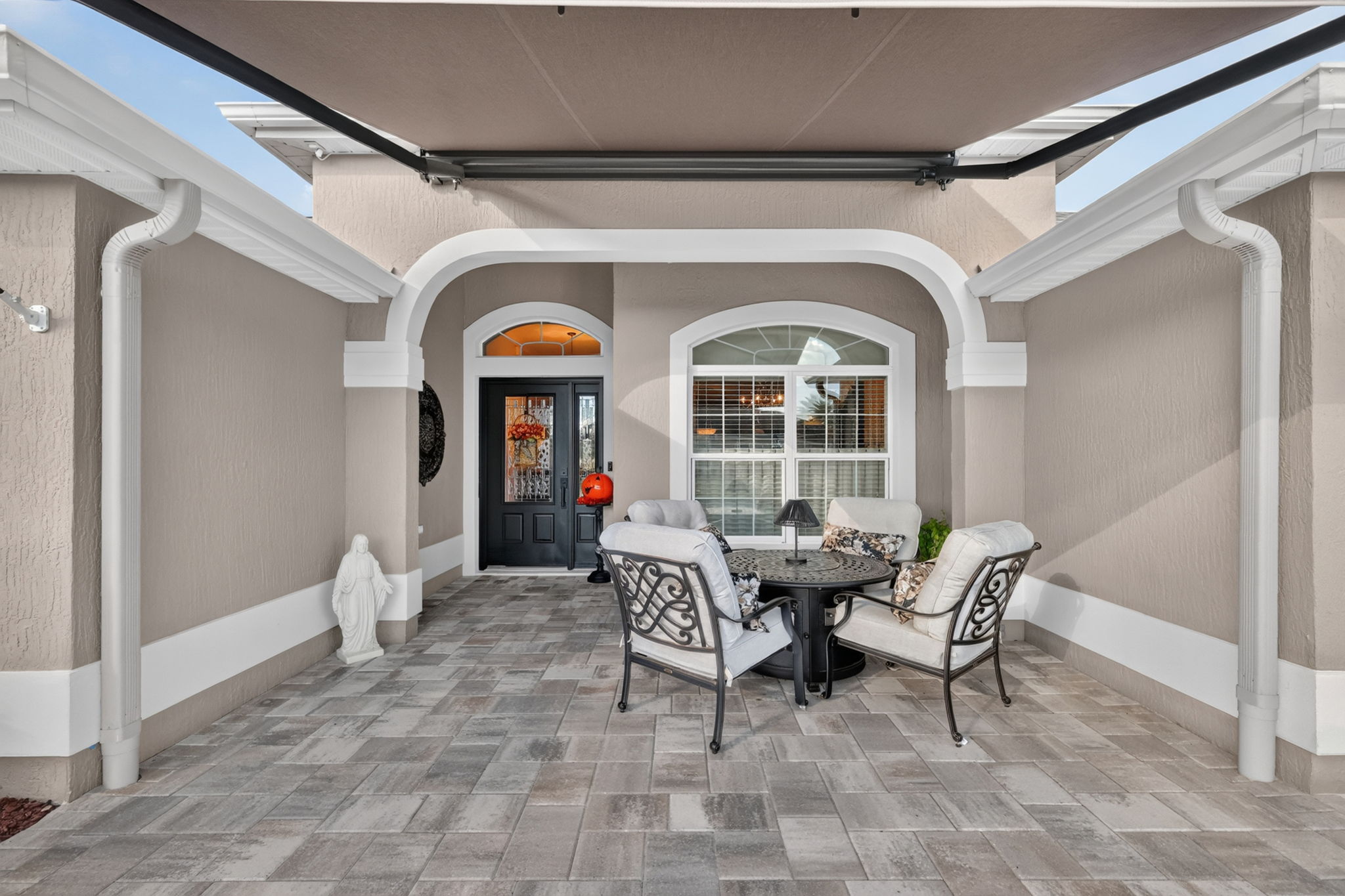 Front Entry with Paver Patio and Remote-Controlled Awning