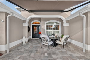 Front Entry with Paver Patio and Remote-Controlled Awning