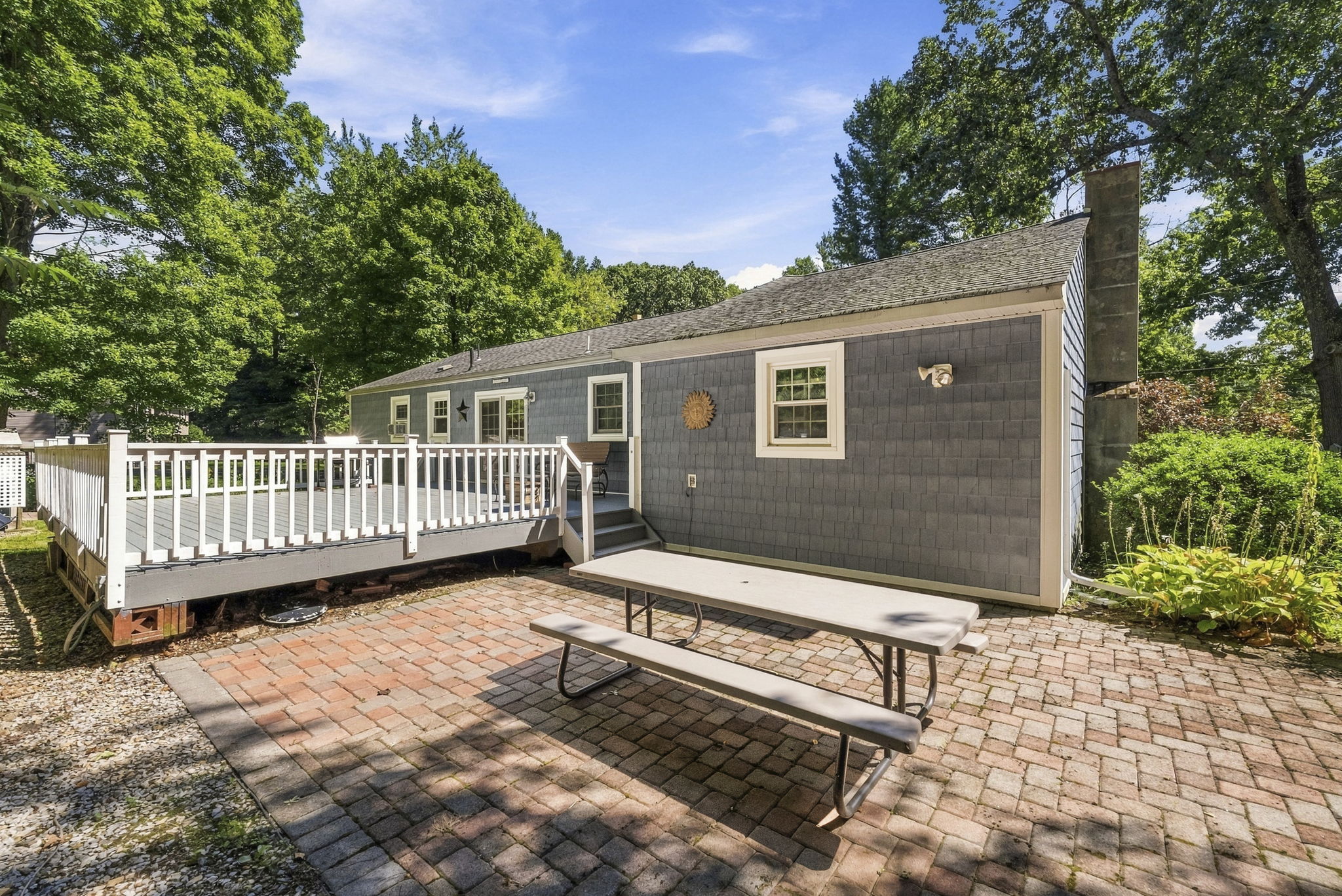 Sliding doors open to an impressive 25-by-25-foot deck. Step down to a patio. Surrounded by mature trees, the backyard offers privacy for outdoor dining, entertaining or simply relaxing.