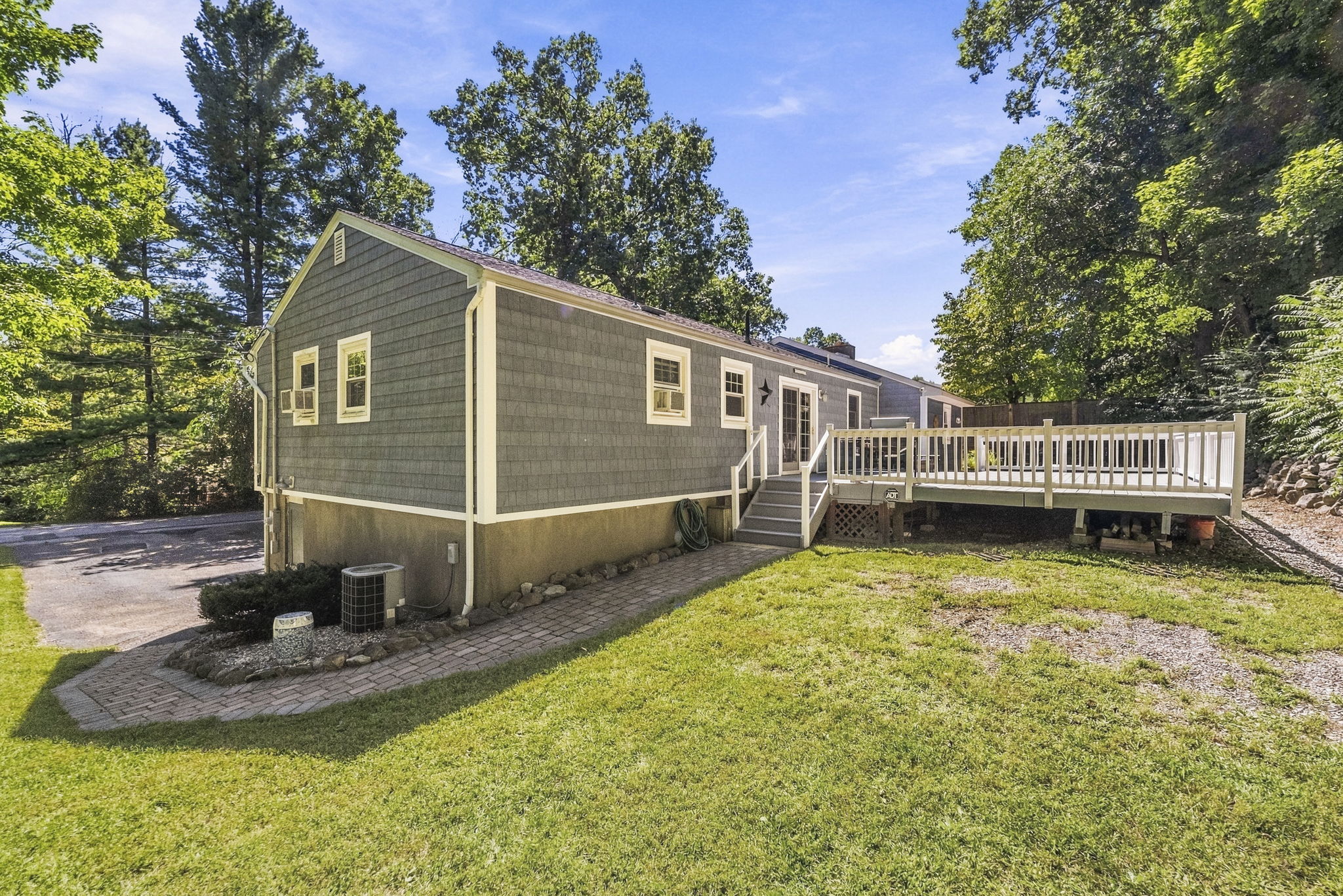 Sliding doors open to an impressive 25-by-25-foot deck. Step down to a patio. Surrounded by mature trees, the backyard offers privacy for outdoor dining, entertaining or simply relaxing.
