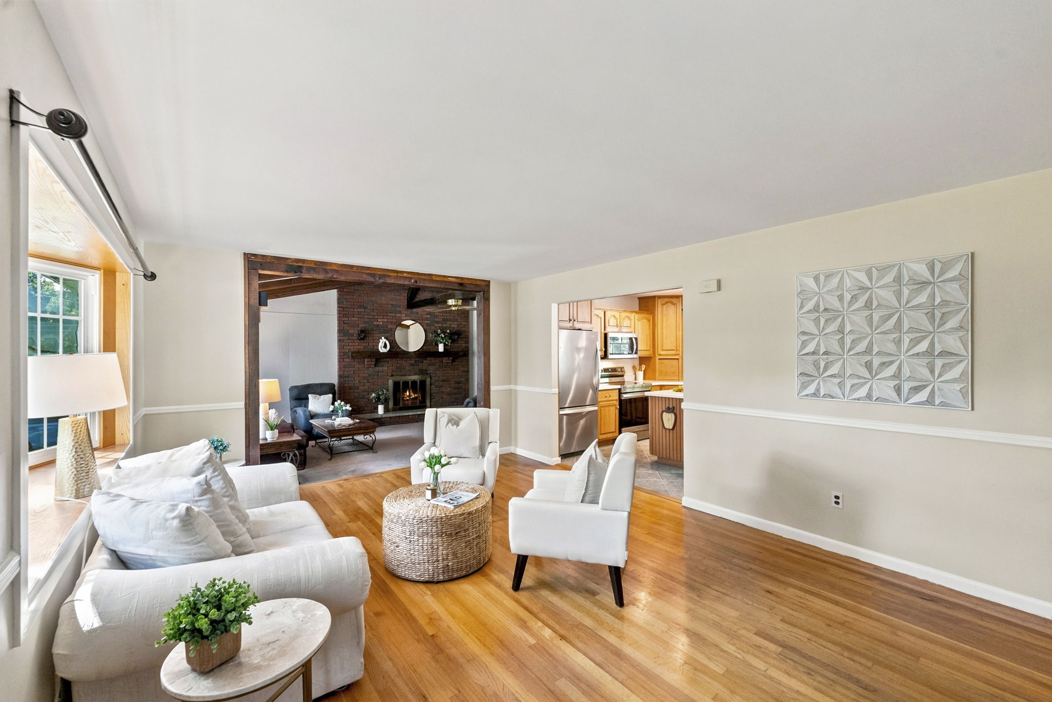 A freshly painted living room features beautiful hardwood floors and abundant natural light.