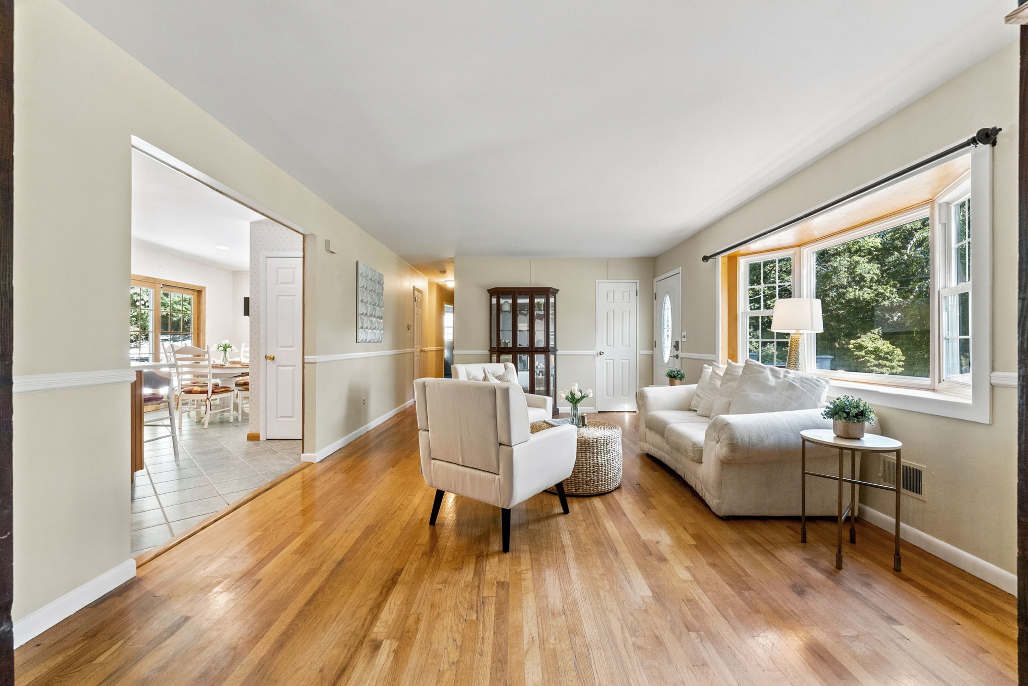 A freshly painted living room features beautiful hardwood floors and abundant natural light.