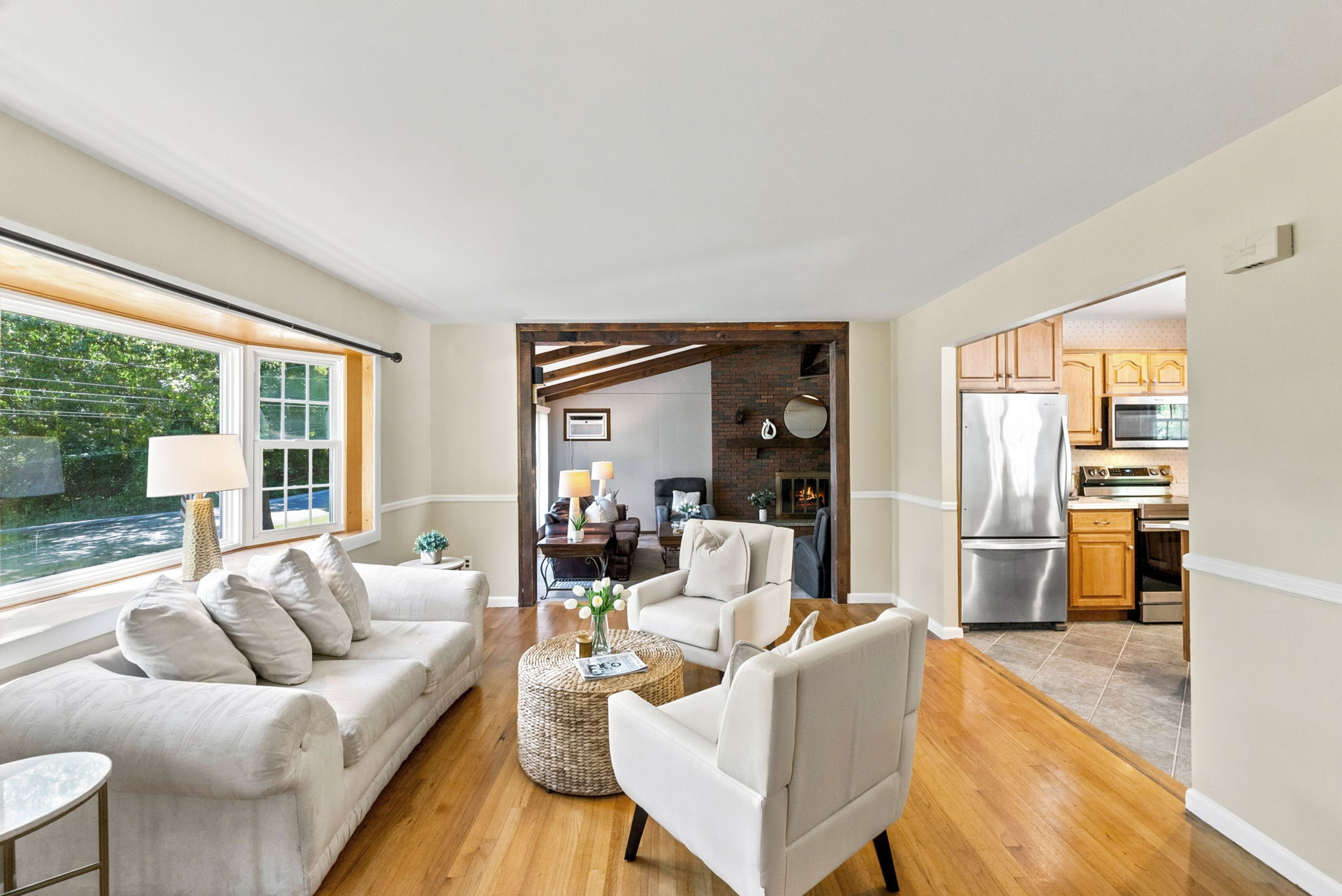 A freshly painted living room features beautiful hardwood floors and abundant natural light.