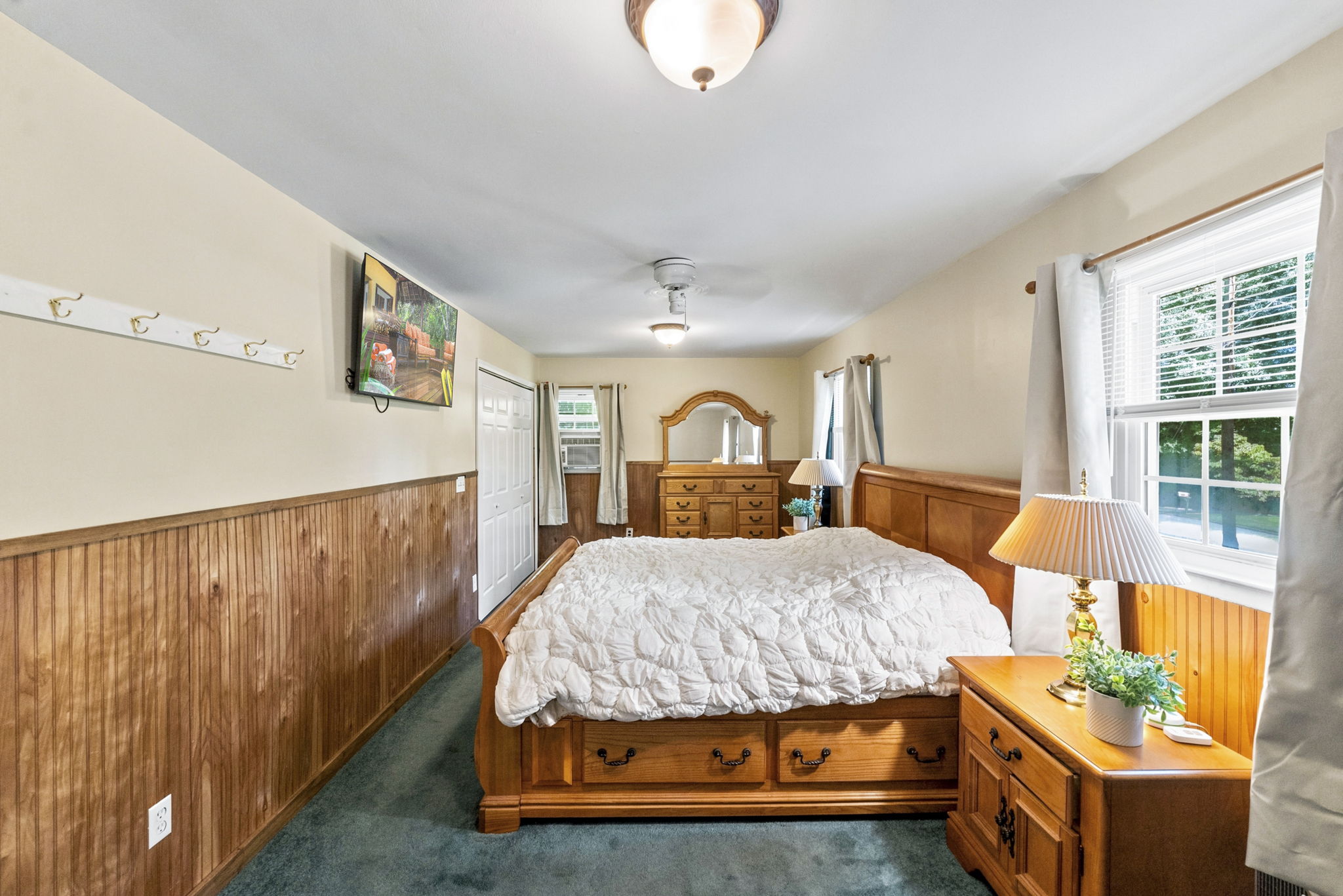 Currently being used as the primary with two sets of closets! Hardwood floors are believed to be beneath the bedroom carpeting, offering additional potential. Previously this was 2 bedrooms, can be converted back.